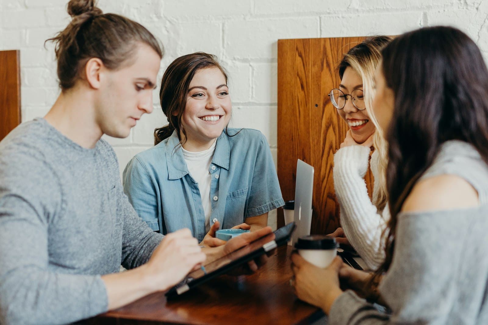Students studying together and laughing around a table